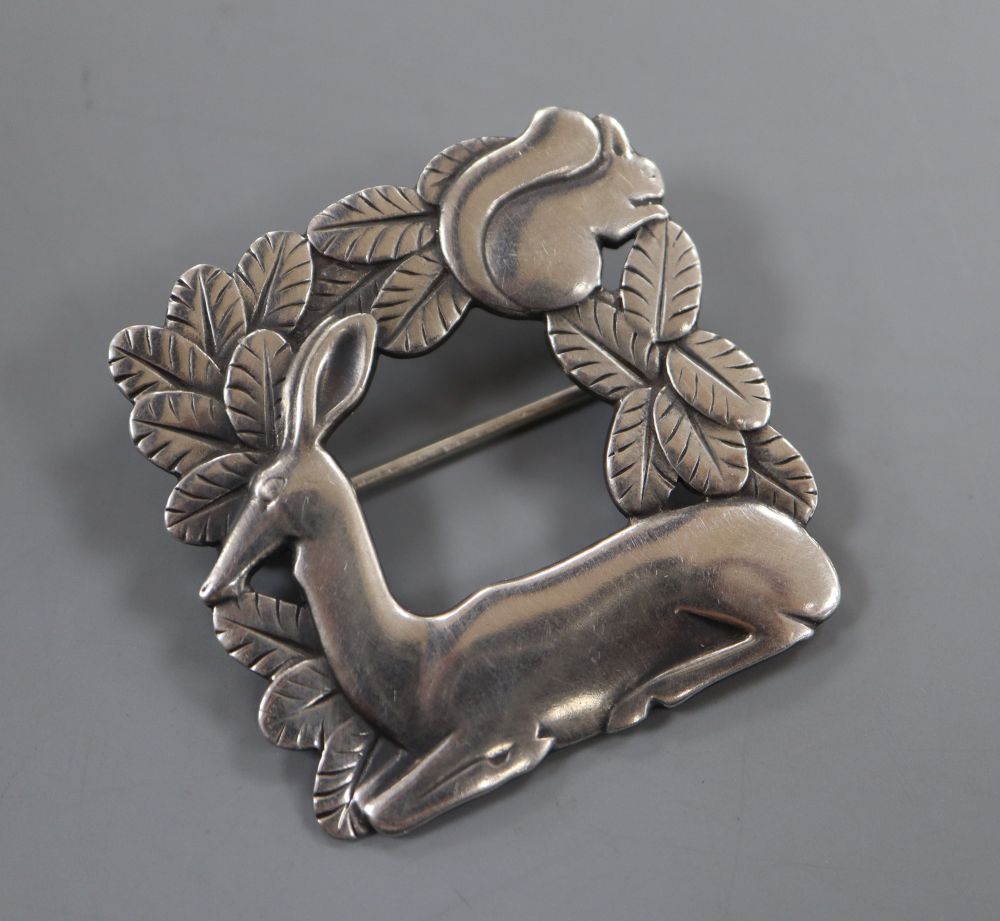 A post 1945 Georg Jensen recumbent deer and squirrel square brooch, design no. 318, 37mm, gross 15 grams.